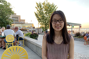 GWS senior Bianca Yue at a terrace table, lake Mendota in the background.