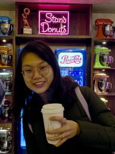 GWS student, Bianca Yue, with a coffee cup at Stan's Donuts.