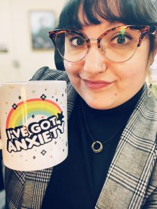 Lyddia holding coffee mug.