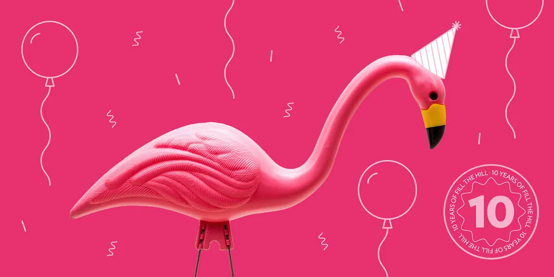 Plastic Flamingo wearing a cone shaped birthday hat