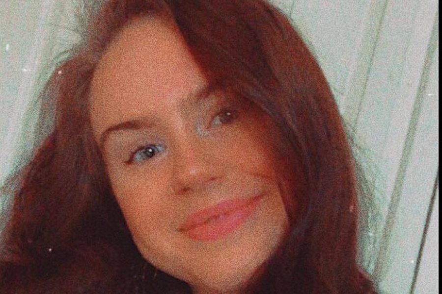 image of India-Bleu Niehoff: a closeup selfie with long auburn hair smiling at the camera.