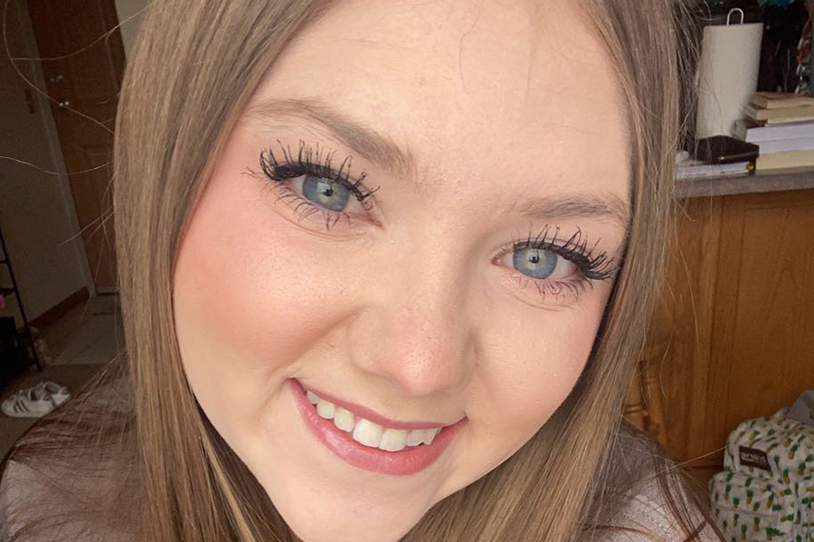 image of McKenzie Raethe: closeup selfie of McKenzie with long brown hair smiling at the camera.