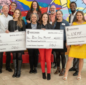 Ollie DiPietro wins the Arts Business Competition and holds a check along with the 2nd and 3rd place winners.