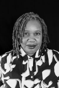 Image of Dr. Ethelene Whitmire in black and white. She wears her hair in locks and has a flowered blouse on.